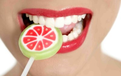 red lipstick on a mouth eating a lolly